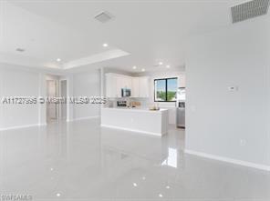 empty room featuring a tray ceiling