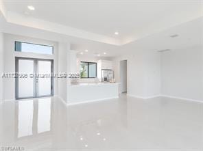 spare room featuring a tray ceiling