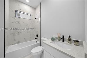 full bathroom with toilet, tiled shower / bath, and vanity