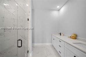 bathroom with a shower with door and vanity