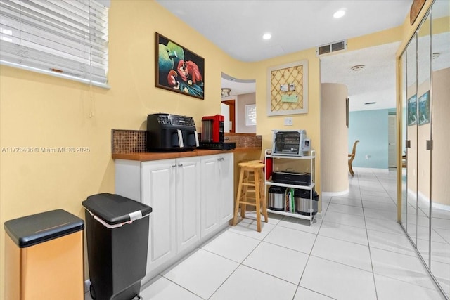 kitchen featuring white cabinets and light tile patterned floors