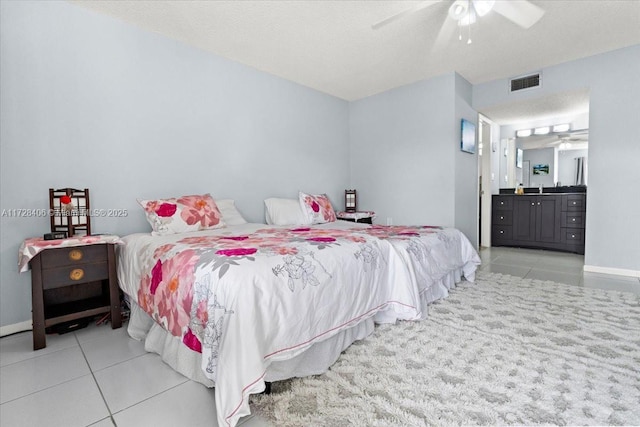 bedroom with ceiling fan, a textured ceiling, and light tile patterned flooring