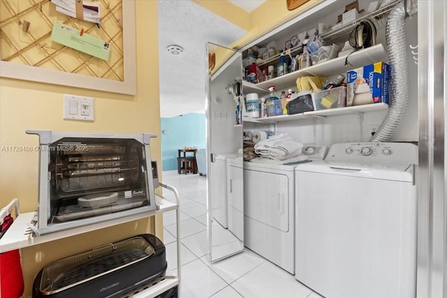 washroom with light tile patterned floors and separate washer and dryer