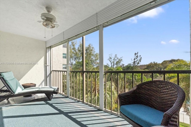 sunroom / solarium featuring ceiling fan