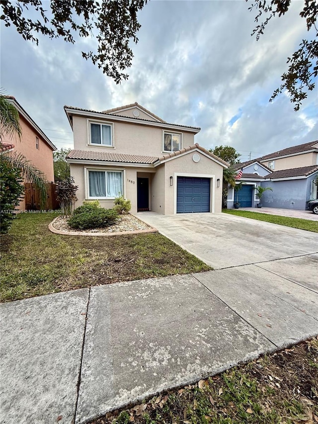 view of front property featuring a garage and a front lawn