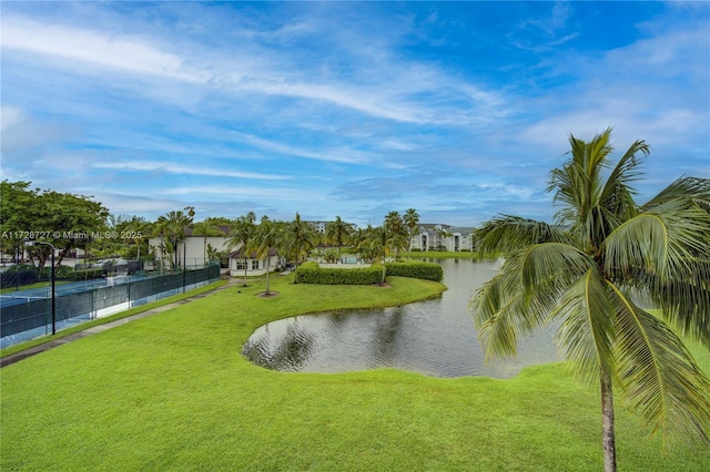 view of home's community with a lawn and a water view