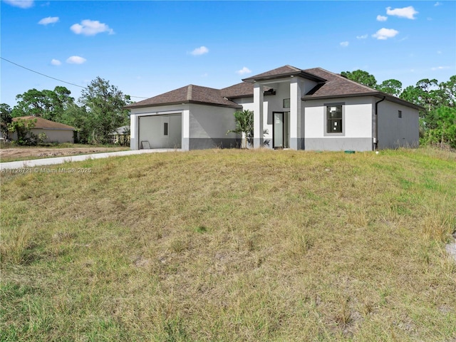 view of front of house featuring a garage and a front yard