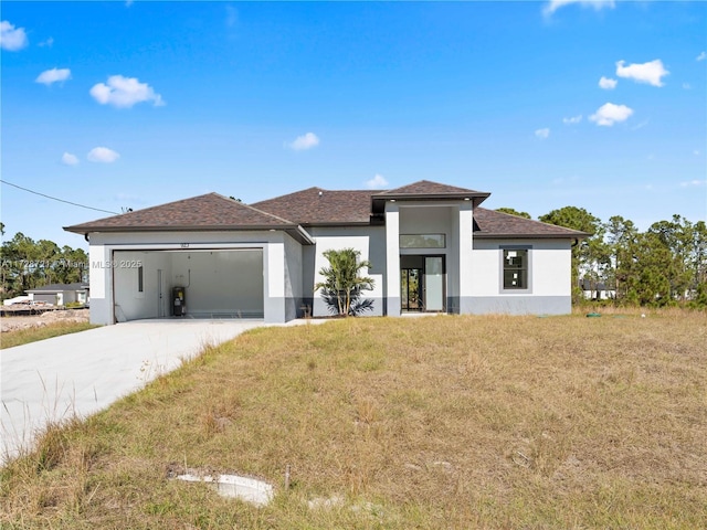 view of front of home with a front yard and a garage