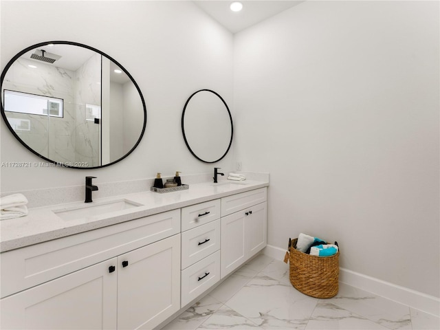 bathroom with a shower with shower door and vanity