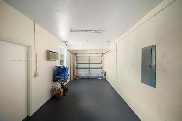 garage featuring a wall mounted air conditioner and electric panel