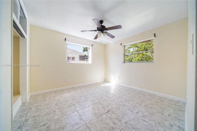 spare room with plenty of natural light and ceiling fan