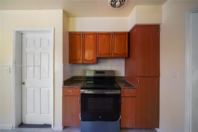 kitchen featuring tasteful backsplash and stainless steel range with electric cooktop