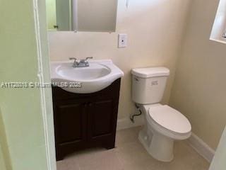 bathroom featuring vanity, toilet, and tile patterned flooring