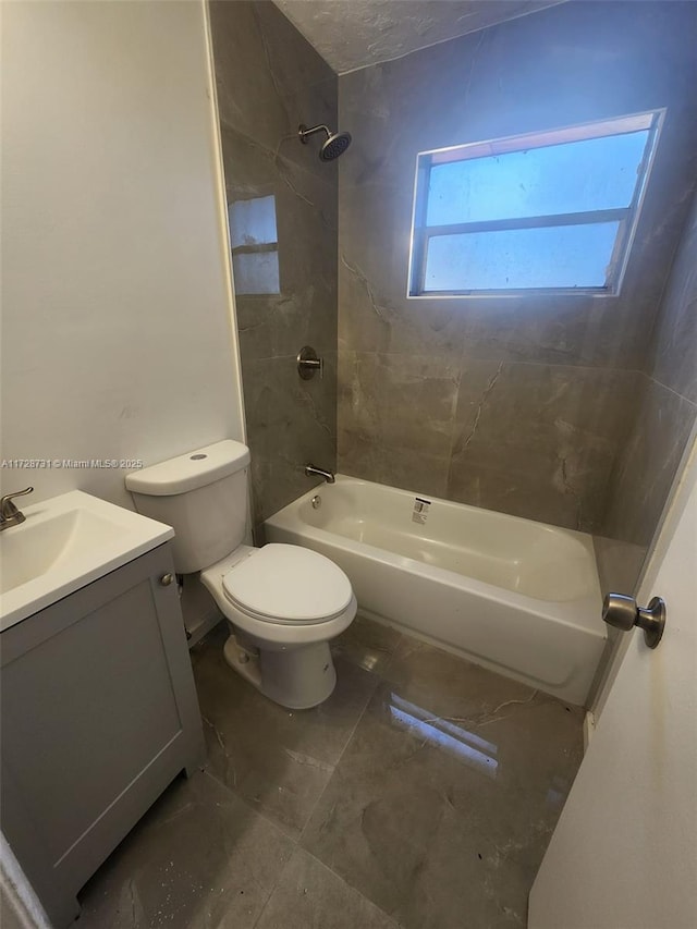 full bathroom featuring toilet, vanity, and tiled shower / bath