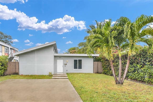 view of front of home featuring a front yard and a patio area