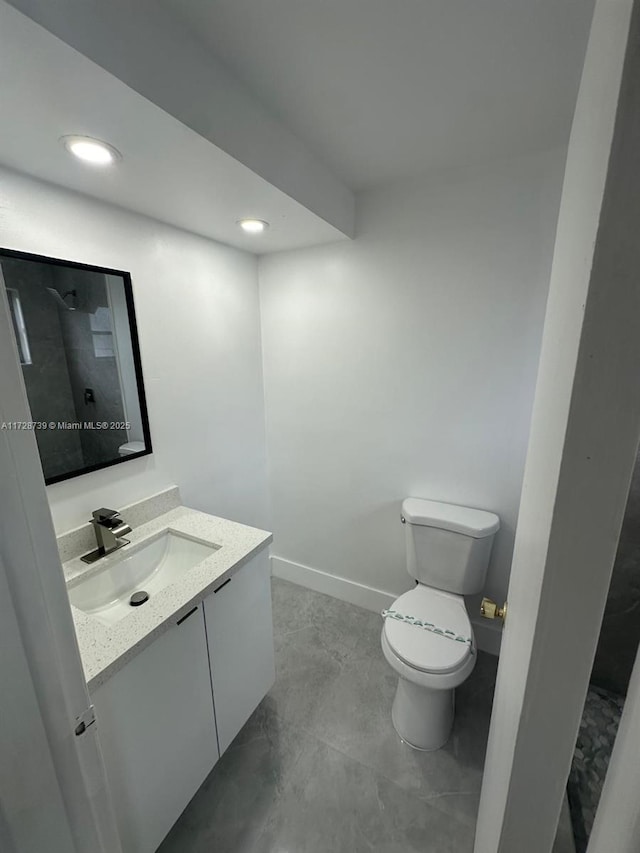 bathroom featuring toilet and vanity