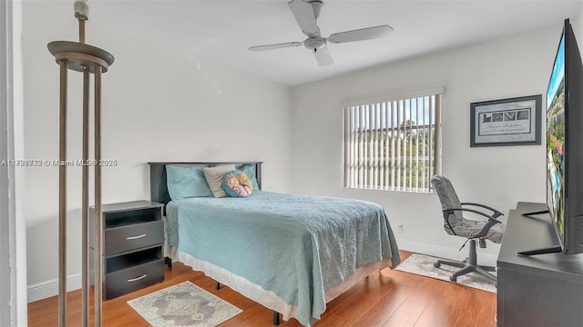 bedroom with ceiling fan and wood-type flooring