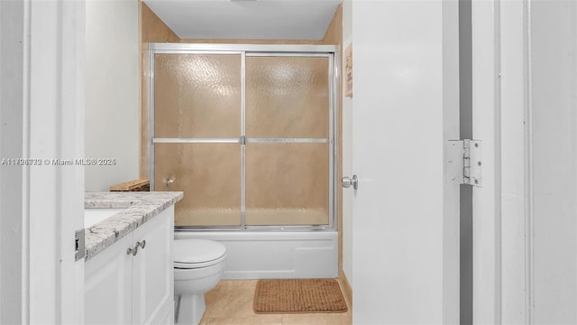 full bathroom with toilet, combined bath / shower with glass door, tile patterned flooring, and vanity