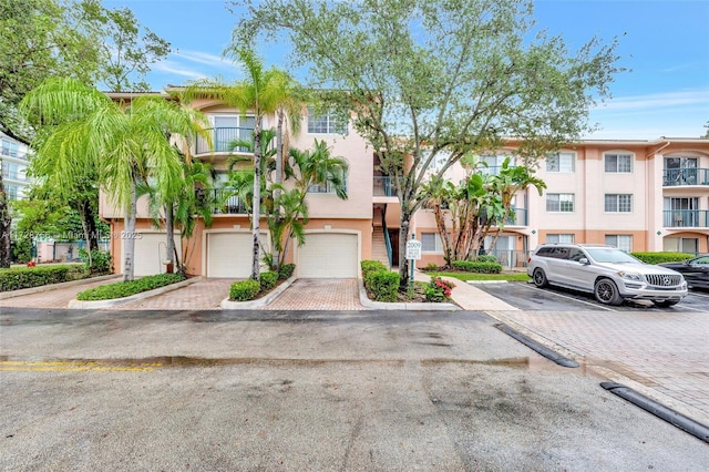 2009 SE 10th Ave Unit 302, Fort Lauderdale, FL 33316 - view of front facade featuring stucco siding and an attached garage