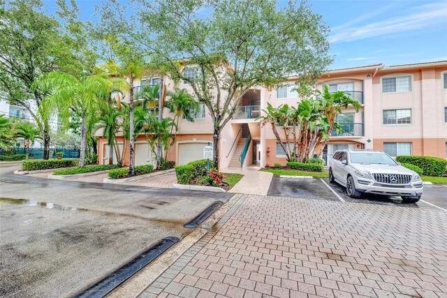 2009 SE 10th Ave Unit 302, Fort Lauderdale, FL 33316 - view of property with stairway and uncovered parking