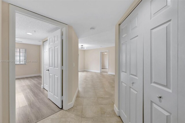 2009 SE 10th Ave Unit 302, Fort Lauderdale, FL 33316 - hall with baseboards, light tile patterned floors, and a textured ceiling