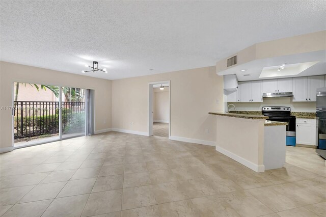 2009 SE 10th Ave Unit 302, Fort Lauderdale, FL 33316 - kitchen with electric stove, under cabinet range hood, a textured ceiling, open floor plan, and white cabinetry