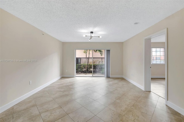 2009 SE 10th Ave Unit 302, Fort Lauderdale, FL 33316 - empty room with plenty of natural light, light tile patterned floors, a textured ceiling, and baseboards