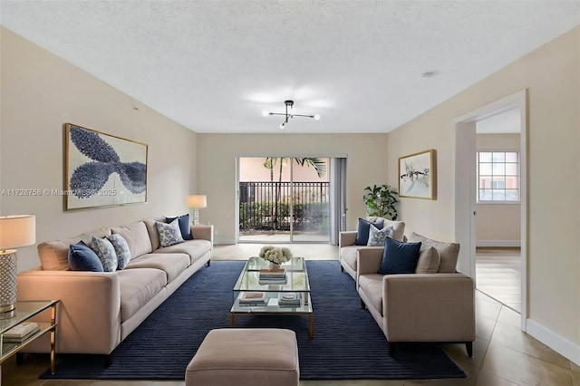 2009 SE 10th Ave Unit 302, Fort Lauderdale, FL 33316 - living area featuring tile patterned floors, baseboards, and a textured ceiling