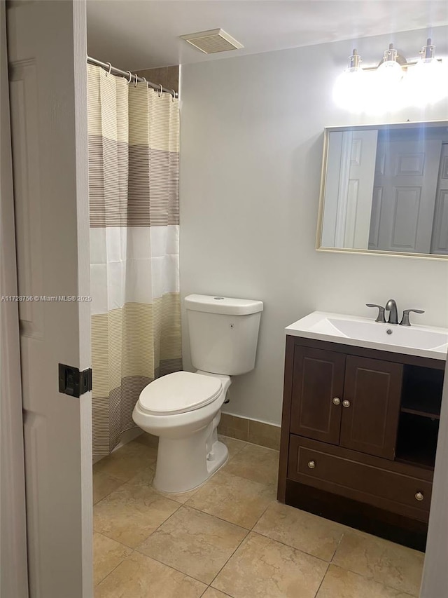 bathroom featuring toilet and vanity