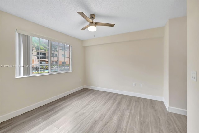 2009 SE 10th Ave Unit 302, Fort Lauderdale, FL 33316 - spare room featuring a ceiling fan, wood finished floors, baseboards, and a textured ceiling
