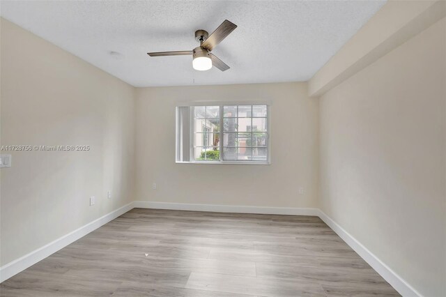 2009 SE 10th Ave Unit 302, Fort Lauderdale, FL 33316 - unfurnished room featuring ceiling fan, light wood-style floors, baseboards, and a textured ceiling