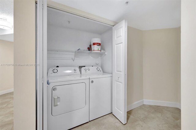 2009 SE 10th Ave Unit 302, Fort Lauderdale, FL 33316 - washroom with separate washer and dryer and baseboards