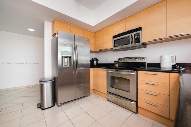 kitchen with light tile patterned floors and appliances with stainless steel finishes