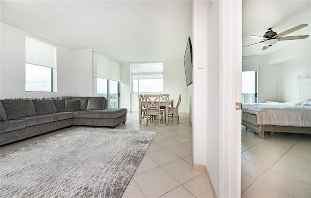 tiled living room featuring ceiling fan