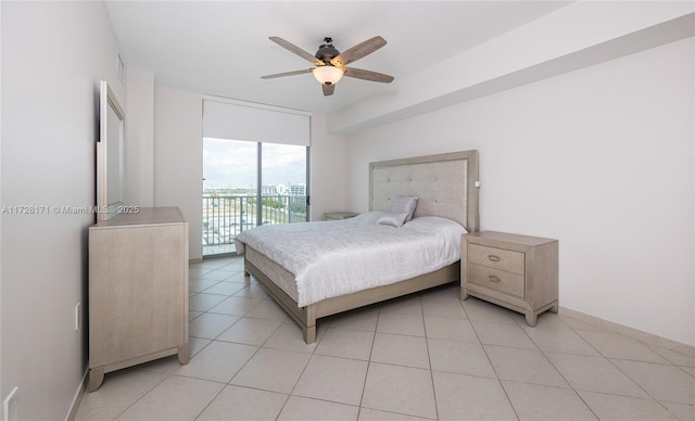 bedroom with ceiling fan, access to exterior, light tile patterned floors, and expansive windows