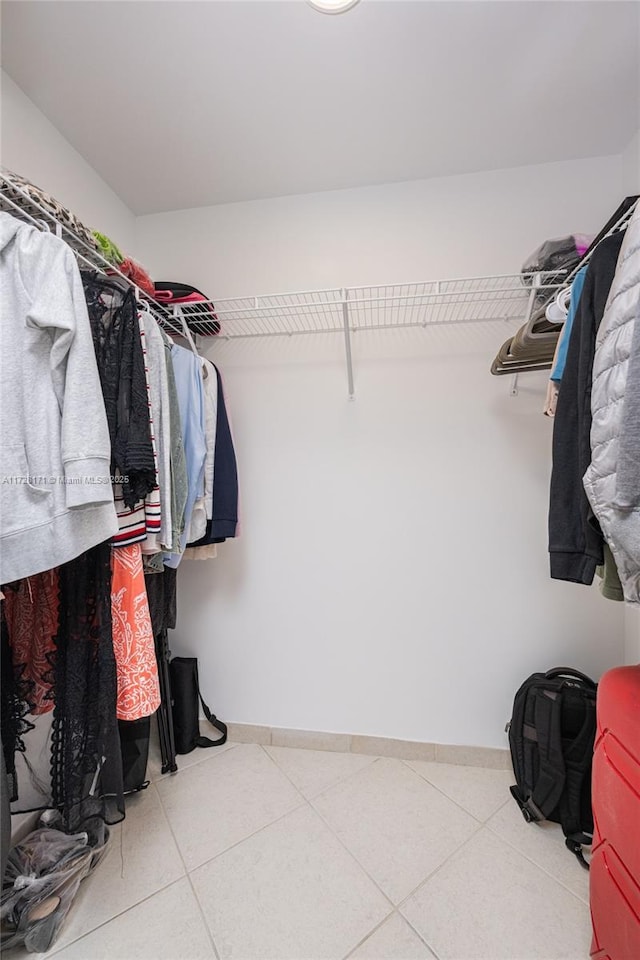 spacious closet featuring tile patterned floors