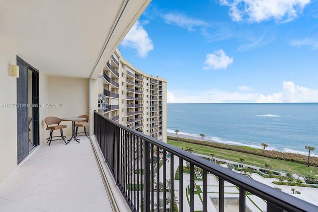 balcony with a beach view and a water view