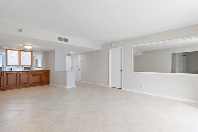 unfurnished living room with light tile patterned floors