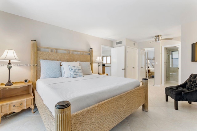 bedroom with ensuite bath, ceiling fan, and light tile patterned flooring