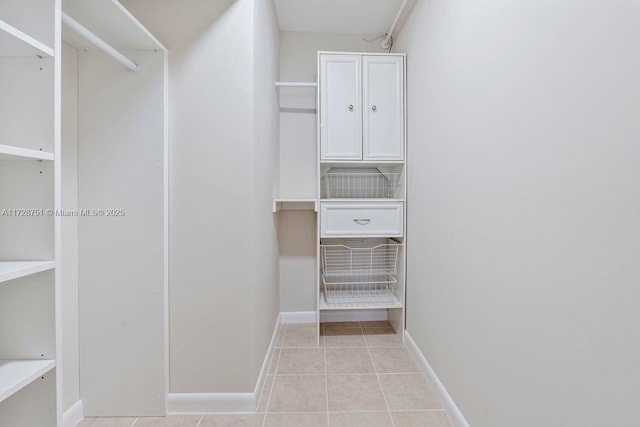 spacious closet featuring light tile patterned floors