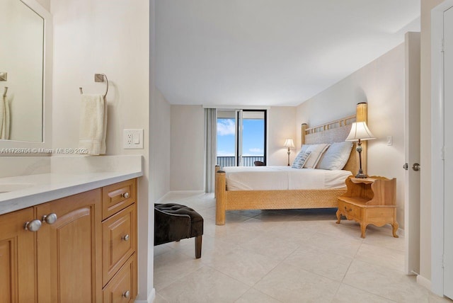 bedroom featuring sink and light tile patterned flooring