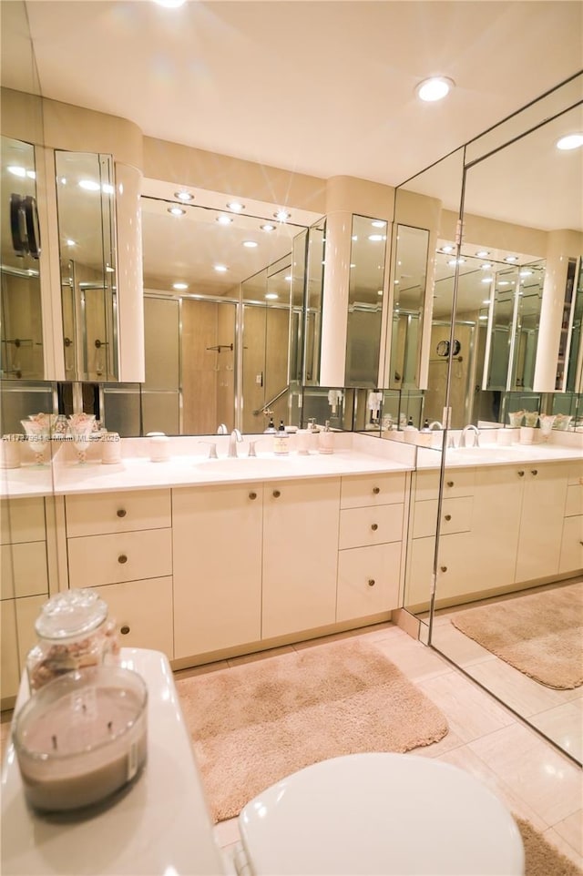 bathroom with vanity, an enclosed shower, and tile patterned flooring