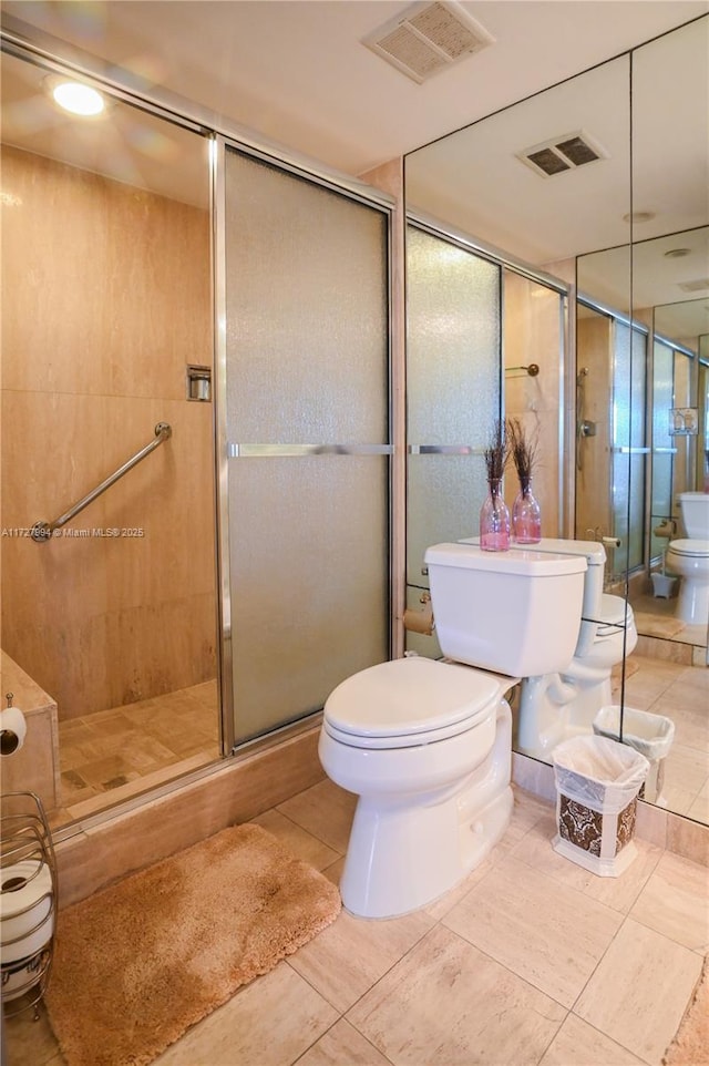 bathroom with tile patterned flooring, a bidet, an enclosed shower, and toilet