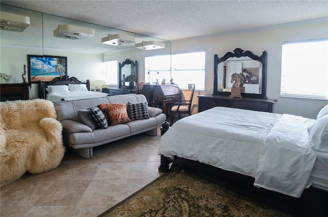 bedroom with a wall mounted air conditioner and a textured ceiling