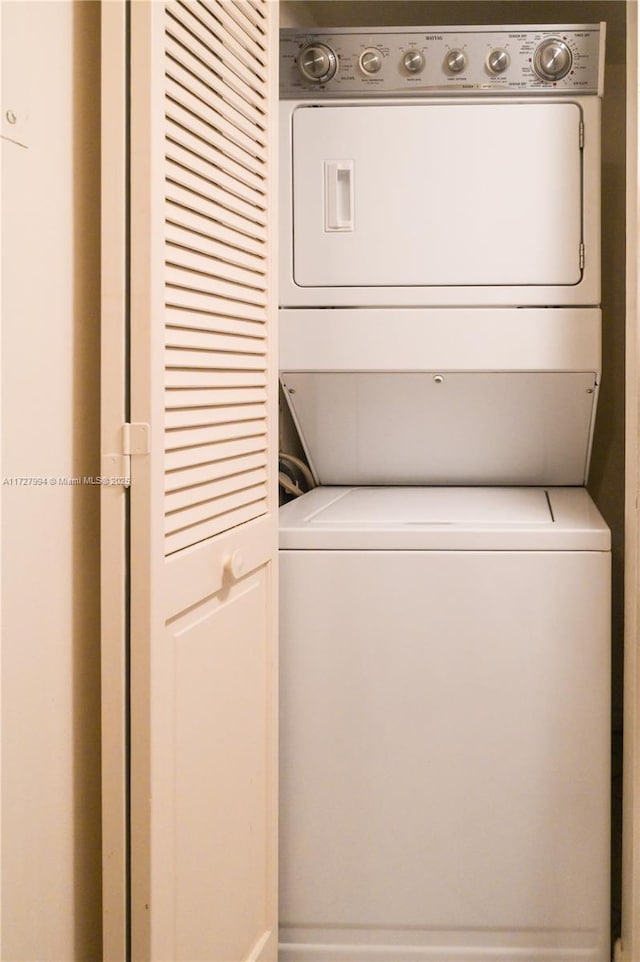 washroom featuring stacked washer and dryer