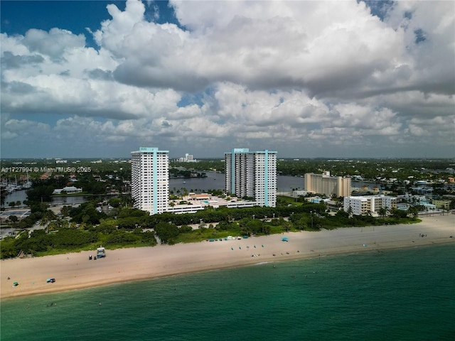 birds eye view of property with a water view and a view of the beach