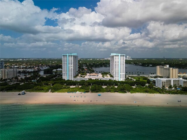 birds eye view of property with a view of the beach and a water view