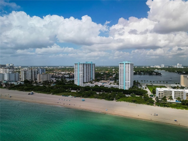 birds eye view of property with a view of the beach and a water view