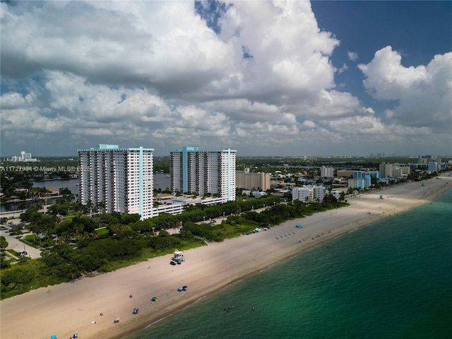 birds eye view of property with a view of the beach and a water view