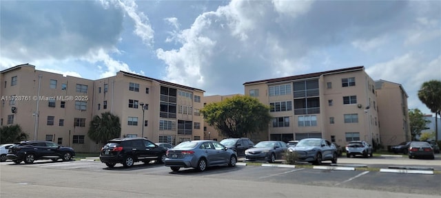 2840 Somerset Dr Unit 318M, Lauderdale Lakes, FL 33311 - view of building exterior featuring uncovered parking